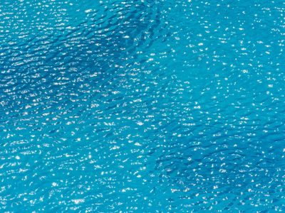 Clean water droplet creating ripples on a surface.